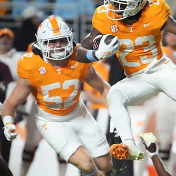 Tennessee defensive back Boo Carter (23) leaps over a Mississippi defender on a punt return during an NCAA college football game on Saturday, Nov. 9, 2024, in Knoxville, Tenn.