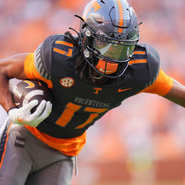 Tennessee wide receiver Chris Brazzell II (17) moves the ball while grabbed by New Mexico State safety Armahn Hale (2) during an NCAA college football game on November 15, 2025, in Knoxville, Tenn.