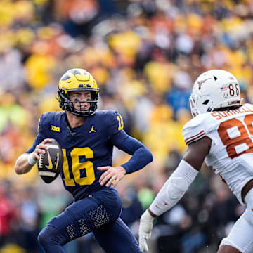 Michigan quarterback Davis Warren (16) looks to makes a pass against Texas linebacker Barryn Sorrell (88) during the second half at Michigan Stadium in Ann Arbor on Saturday, September 7, 2024.