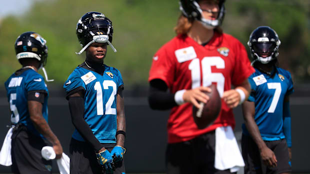 Jacksonville Jaguars wide receiver Travis Hunter (12) looks on to quarterback Trevor Lawrence (16) during the 10th organized 