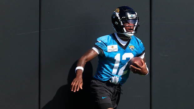 Jacksonville Jaguars wide receiver Travis Hunter (12) hits the padded wall after a sucessful reception during the second mand