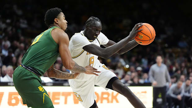 Feb 22, 2025; Boulder, Colorado, USA; Colorado Buffaloes forward Bangot Dak (8) shoots the ball over Baylor Bears guard Langs