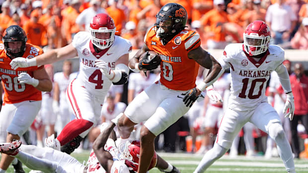 Oklahoma State's Ollie Gordon II (0) rushes in the second half of the college football game