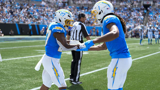  Los Angeles Chargers wide receiver Quentin Johnston (1) congratulates running back J.K. Dobbins (27) on his score against th