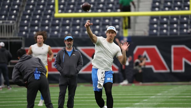 Los Angeles Chargers quarterback Justin Herbert (10) warms up before playing against the Houston Texans in an AFC wild card g