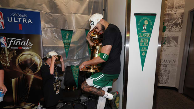 Jun 17, 2024; Boston, Massachusetts, USA; Boston Celtics forward Jayson Tatum (0) holds the Larry O’Brien Championship Trophy after their win against the Dallas Mavericks after game five of the 2024 NBA Finals at TD Garden. Mandatory Credit: Elsa/Pool Photo-USA TODAY Sports