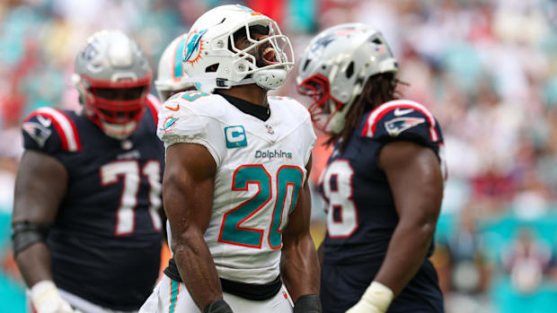 Dolphins linebacker Jordyn Brooks (White and Teal Uniform) reacts after play.