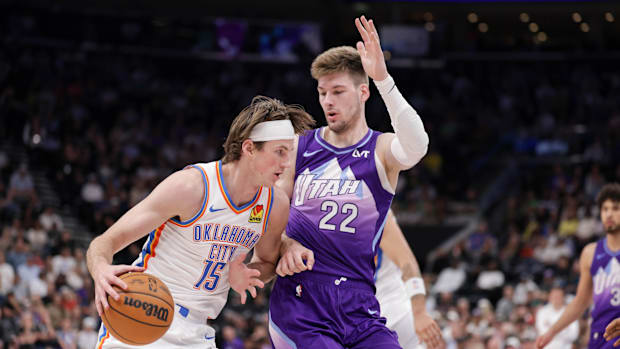 Oklahoma City Thunder center Branden Carlson (15) tries to dribble past Utah Jazz forward Kyle Filipowski (22)