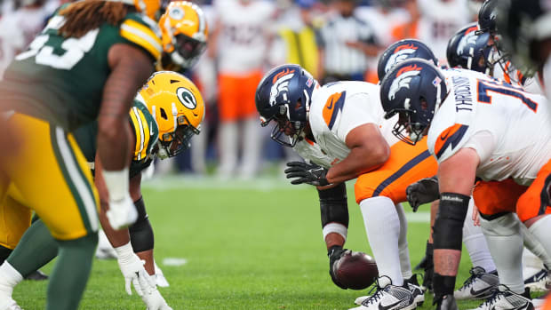 Denver Broncos center Sam Mustipher (61) snaps the ball in the second quarter against the Green Bay Packers at Empower Field.