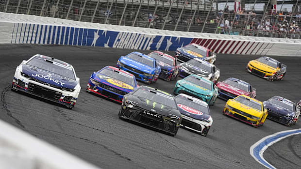 Ross Chastain (1) takes the lead away from driver Ty Gibbs (54) at Charlotte Motor Speedway.