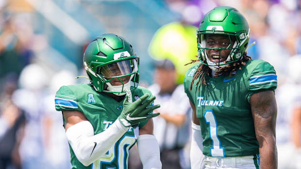 Tulane defensive back Jahiem Johnson and safety Jack Tchienchou react during their win over Northwestern.
