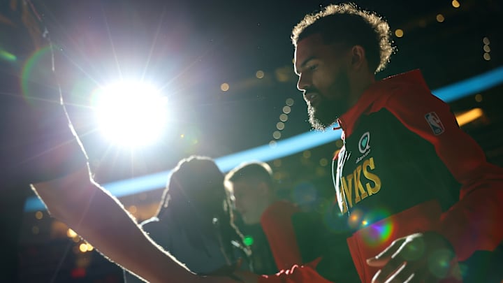 Trae Young walks onto the floor after being introduced as a starter in Atlanta's Play-In matchup against the Heat last season.