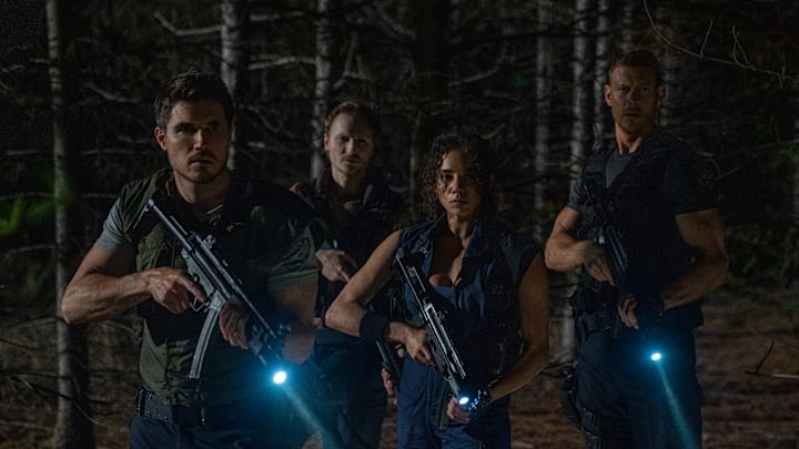 Robbie Amell, Chad Rook, Hannah John Kamen, and Tom Hopper in Screen Gems RESIDENT EVIL WELCOME TO RACCOON CITY.