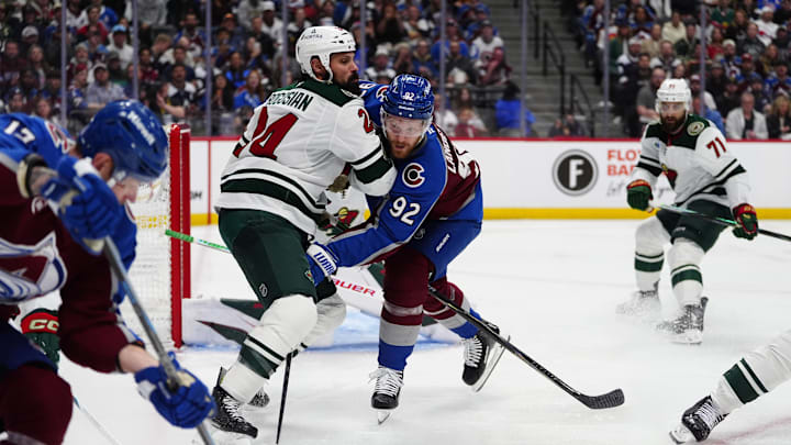 May 3, 2026; Denver, Colorado, USA; Minnesota Wild defenseman Zach Bogosian (24) collides into Colorado Avalanche left wing Gabriel Landeskog (92) during the second period in game one of the second round of the 2026 Stanley Cup Playoffs at Ball Arena. Mandatory Credit: Ron Chenoy-Imagn Images