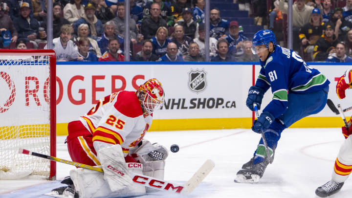 Apr 16, 2024; Vancouver, British Columbia, CAN; Calgary Flames goalie Jacob Markstrom (25) makes a save on Vancouver Canucks forward Dakota Joshua (81) in the third period at Rogers Arena. Canucks won 4 -1. Mandatory Credit: Bob Frid-USA TODAY Sports