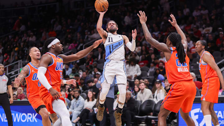 Hawks guard Trae Young (11) shoots against the Oklahoma City Thunder in the third quarter at State Farm Arena. 