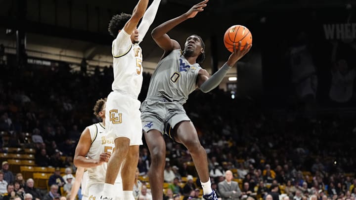Jan 12, 2025; Boulder, Colorado, USA; West Virginia Mountaineers center Eduardo Andre (0) shoots the ball at Colorado Buffaloes guard RJ Smith (5) in the first half at CU Events Center. Mandatory Credit: Ron Chenoy-Imagn Images