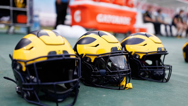 Dec 31, 2024; Tampa, FL, USA; Michigan Wolverines helmets sit on the field before a game against the Alabama Crimson Tide at Raymond James Stadium. Mandatory Credit: Matt Pendleton-Imagn Images