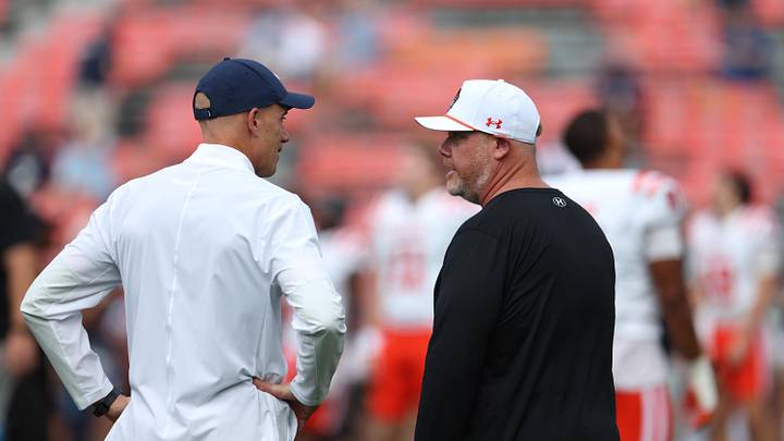 Nov 22, 2025; Auburn, Alabama, USA; Mercer Bears head coach Mike Jacobs and Auburn Tigers interim head coach DJ Durkin talk before their game at Jordan-Hare Stadium. Mandatory Credit: John Reed-Imagn Images