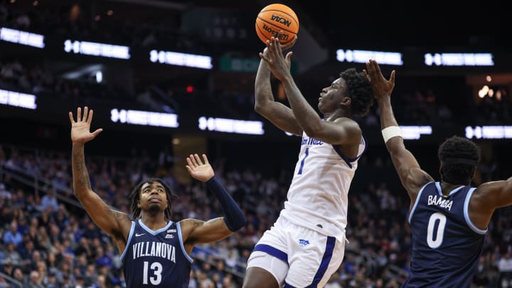 Mar 6, 2024; Newark, New Jersey, USA; Seton Hall Pirates guard Kadary Richmond (1) shoots the ball as Villanova Wildcats guard Hakim Hart (13) and guard TJ Bamba (0) defend during the second half at Prudential Center. Mandatory Credit: Vincent Carchietta-USA TODAY Sports