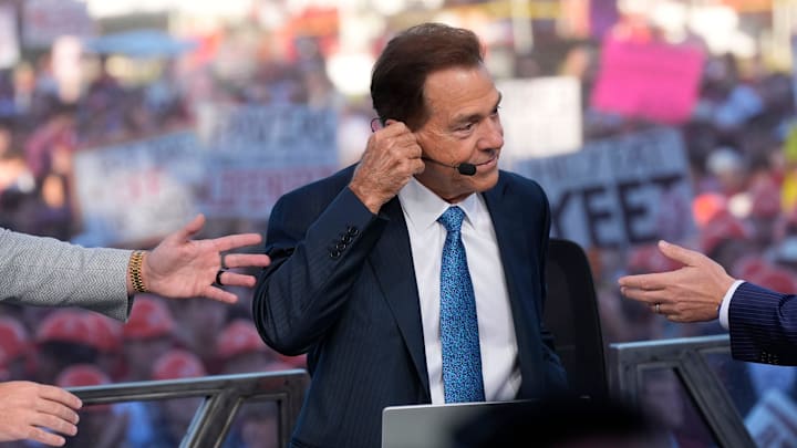 Oct. 4, 2025; Tuscaloosa, Alabama, USA; Co-hosts reach out to Nick Saban on the set of ESPN’s College GameDay on location on the Quad at the University of Alabama before the Alabama versus Vanderbilt game.