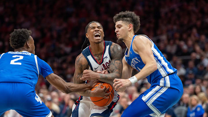Dec 7, 2024; Seattle, Washington, USA;  Gonzaga Bulldogs guard Khalif Battle (99), center, drives agaoinst Kentucky Wildcats guard Jaxson Robinson (2) aND guard Koby Brea (4) during the first half at Climate Pledge Arena. Mandatory Credit: Stephen Brashear-Imagn Images