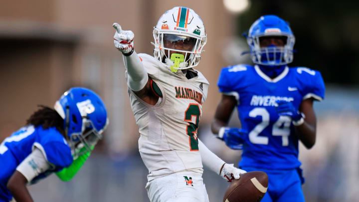 Mandarin's Jaime Ffrench Jr. (2) reacts to a first down pick up against Riverside's King Taylor (12) and Ronald \"RJ\" Bertrand (24) during the second quarter of a regular season high school football matchup Friday, Sept. 8, 2023 at Riverside High School in Jacksonville, Fla. The Mandarin Mustangs defeated the Riverside Generals 50-20. [Corey Perrine/Florida Times-Union]