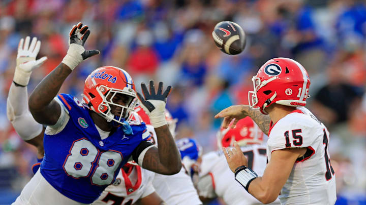 Georgia Bulldogs quarterback Carson Beck (15) is pressured by Florida Gators defensive lineman Caleb Banks (88) during the third quarter of an NCAA football game Saturday, Oct. 28, 2023 at EverBank Stadium in Jacksonville, Fla. Georgia defeated Florida 43-20.