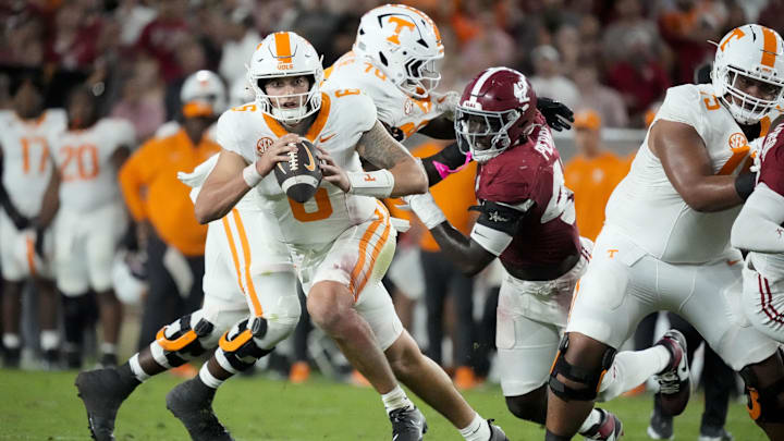 Oct 18, 2025; Tuscaloosa, Alabama, USA; Tennessee Volunteers quarterback Joey Aguilar (6) scrambles and looks for a receiver as he is pursued by Alabama Crimson Tide wide receiver Ben Jackson (42) in the second quarter at Saban Field at Bryant-Denny Stadium. Mandatory Credit: Gary Cosby-USA TODAY Network via Imagn Images