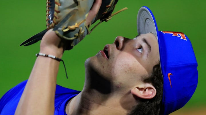 Florida infielder Brendan Lawson (11) catches an out during the eighth inning of an NCAA baseball matchup.