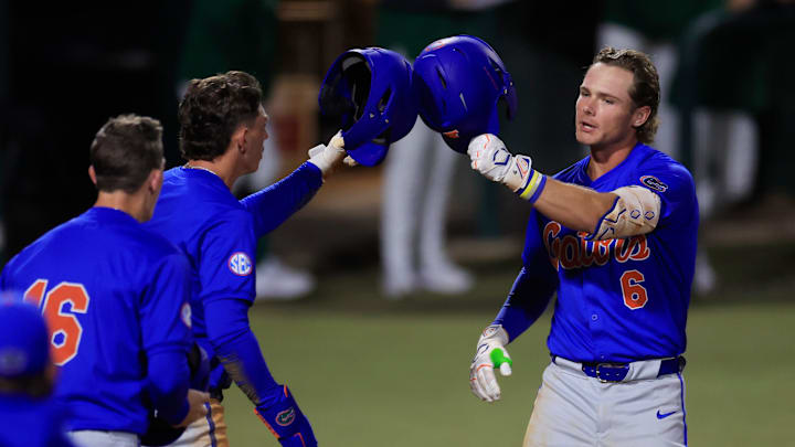 Florida utility Bobby Boser (6) taps helmets with infielder Justin Nadeau (1) after hitting a three-run home run during the fifth inning of an NCAA baseball matchup Monday, Feb. 17, 2025 at Jacksonville University in Jacksonville, Fla. Florida defeated Jacksonville 10-4. [Corey Perrine/Florida Times-Union]