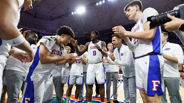 Mar 8, 2025; Gainesville, Florida, USA; Florida Gators guard Walter Clayton Jr. (1), center Rueben Chinyelu (9), and head coach Todd Golden clap after a game against the Ole Miss.