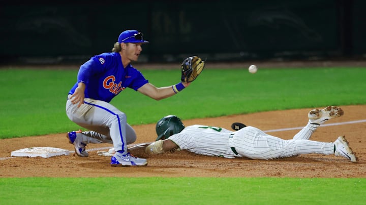 Jacksonville outfielder Jaden Bastian (8) beats the tag at third base from Florida utility Bobby Boser (6) during the fifth inning of an NCAA baseball matchup Monday, Feb. 17, 2025 at Jacksonville University in Jacksonville, Fla. Florida defeated Jacksonville 10-4. [Corey Perrine/Florida Times-Union]