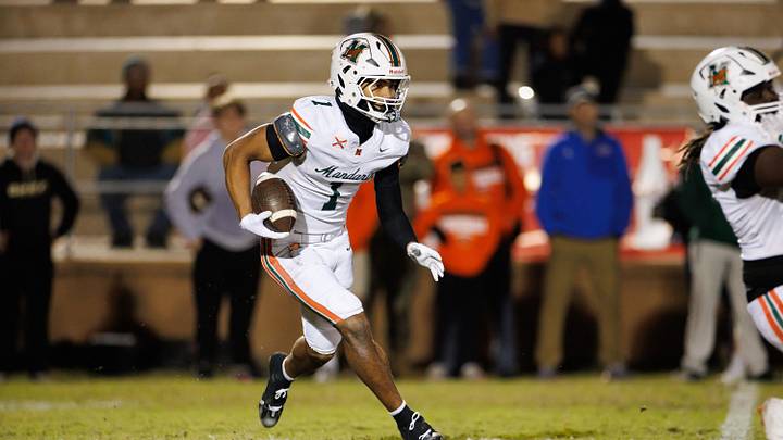Mandarin Mustangs wide receiver Brysen Wright (1) runs with the ball against the Buchholz Bobcats during the first half at the 2025 FHSAA Football State Championships 6A Regional Finals at Citizens Field in Gainesville, FL on Friday, November 28, 2025. [Matt Pendleton/Gainesville Sun]