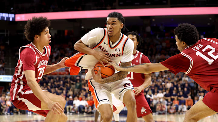 Jan 10, 2026; Auburn, Alabama, USA;  Auburn Tigers guard Elyjah Freeman (6) is guarded by Arkansas Razorbacks forward Malique Ewin (12) and forward Isaiah Sealy (30) during the second half at Neville Arena.  Mandatory Credit: John Reed-Imagn Images