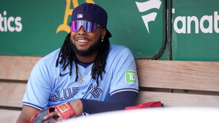 Jun 8, 2024; Oakland, California, USA; Toronto Blue Jays first baseman Vladimir Guerrero Jr. (27) smiles in the dugout before the start of the game against the Oakland Athletics at Oakland-Alameda County Coliseum. Mandatory Credit: Cary Edmondson-USA TODAY Sports