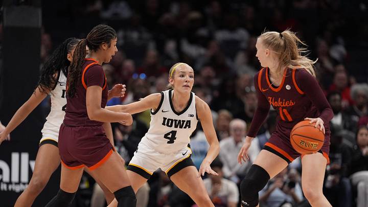 Nov 10, 2024; Charlotte, NC, USA; Iowa Hawkeyes guard Kylie Feuerbach (4) on defense against Virginia Tech Hokies guard Matilda Ekh (11) during the first half at Spectrum Center. Mandatory Credit: Jim Dedmon-Imagn Images