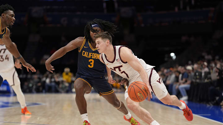 Mar 11, 2025; Charlotte, NC, USA; Virginia Tech Hokies guard Brandon Rechsteiner (7) drives to the basket against California Golden Bears guard DJ Campbell (3) during OT at Spectrum Center. Mandatory Credit: Jim Dedmon-Imagn Images