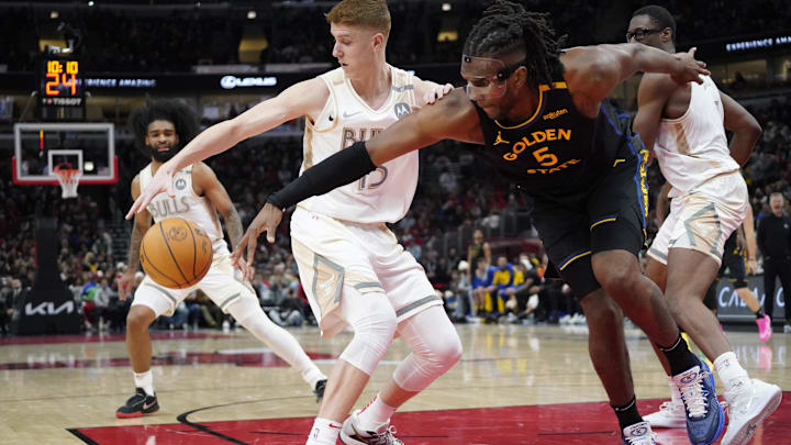 Feb 8, 2025; Chicago, Illinois, USA; Chicago Bulls guard Kevin Huerter (13) and Golden State Warriors forward Kevon Looney (5) chase the ball during the first half at United Center. Mandatory Credit: David Banks-Imagn Images