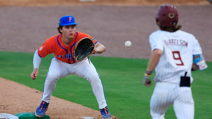 Florida infielder Brendan Lawson (11) fields the throw to get Florida St. outfielder Gage Harrelson (9) out at first base during the fourth inning of an NCAA college baseball matchup Tuesday, March 25, 2025 at VyStar Ballpark in Jacksonville, Fla. FSU rallied to defeat UF 8-4 off a walk-off grand slam from Alex Lodise in the ninth inning. [Corey Perrine/Florida Times-Union]