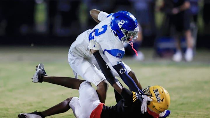 Riverside's Tae’shaun Gelsey (2) fends off Ed White's Jacquari Parks (7) but just shy of a first down turning it over on downs during the third quarter of a high school football matchup Friday, Oct. 25, 2024 at Ed White High School in Jacksonville, Fla. Ed White edged Riverside 21-20 and captured the District 4-4A title and automatic playoff berth. [Corey Perrine/Florida Times-Union]