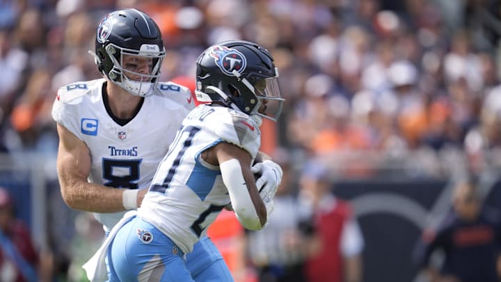 Tennessee Titans quarterback Will Levis (8) hands off to running back Tony Pollard (20) during the third quarter at Soldier Field in Chicago, Ill., Sunday, Sept. 8, 2024.