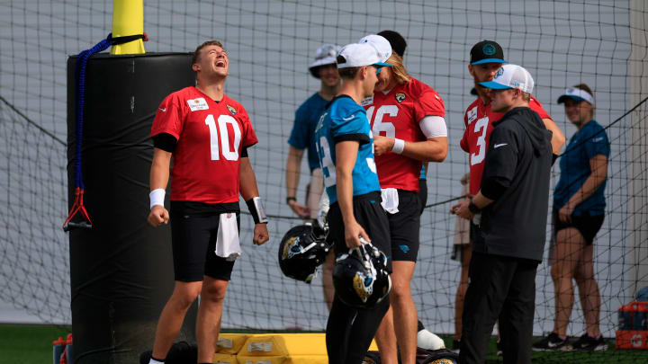 Jacksonville Jaguars quarterback Mac Jones (10) laughs with teammates during a combined NFL football training camp session between the Tampa Bay Buccaneers and Jacksonville Jaguars Thursday, Aug. 15, 2024 at EverBank Stadium’s Miller Electric Center in Jacksonville, Fla. [Corey Perrine/Florida Times-Union]