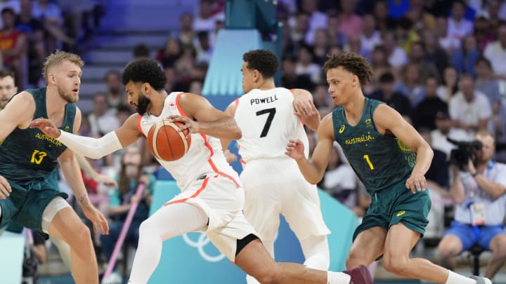 Jul 30, 2024; Villeneuve-d'Ascq, France; Canada guard Jamal Murray (4) moves the ball around Australia centre Jock Landale (13) and Australia point guard Dyson Daniels (1) in a men's group stage basketball match during the Paris 2024 Olympic Summer Games at Stade Pierre-Mauroy. Mandatory Credit: John David Mercer-USA TODAY Sports