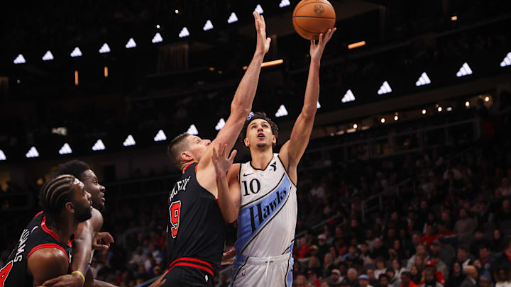 Dec 26, 2024; Atlanta, Georgia, USA; Atlanta Hawks forward Zaccharie Risacher (10) shoots past Chicago Bulls center Nikola Vucevic (9) in the first quarter at State Farm Arena. Mandatory Credit: Brett Davis-Imagn Images
Dec 26, 2024; Atlanta, Georgia, USA; Atlanta Hawks forward Zaccharie Risacher (10) shoots past Chicago Bulls center Nikola Vucevic (9) in the first quarter at State Farm Arena. Mandatory Credit: Brett Davis-Imagn Images