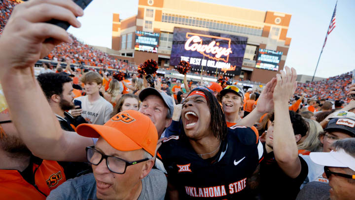 Oklahoma State Cowboys running back Ollie Gordon II (0) celebrates with fans after a Bedlam college football game between the Oklahoma State University Cowboys (OSU) and the University of Oklahoma Sooners (OU) at Boone Pickens Stadium in Stillwater, Okla., Saturday, Nov. 4, 2023. Oklahoma State won 27-24.