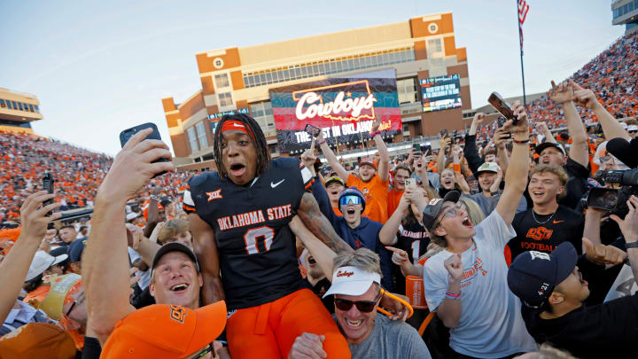 Oklahoma State Cowboys running back Ollie Gordon II (0) celebrates with fans after a Bedlam college football game between the Oklahoma State University Cowboys (OSU) and the University of Oklahoma Sooners (OU) at Boone Pickens Stadium in Stillwater, Okla., Saturday, Nov. 4, 2023. Oklahoma State won 27-24.