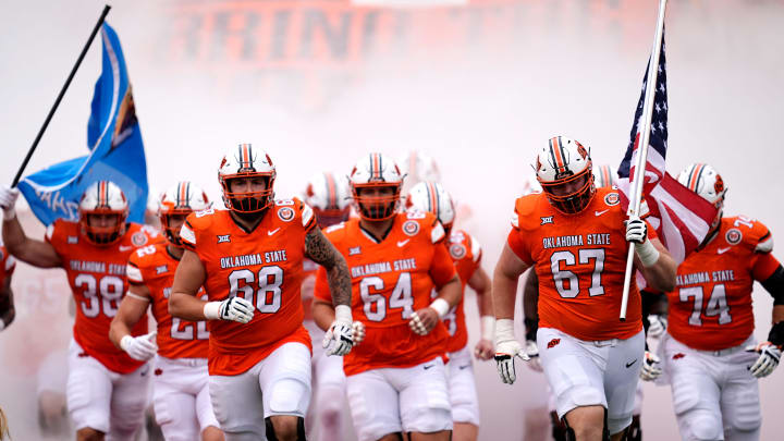 Oklahoma State runs on to the field before the college football game between the Oklahoma State Cowboys and South Dakota State Jackrabbits at Boone Pickens Stadium in Stillwater, Okla., Saturday, Aug., 31, 2024.