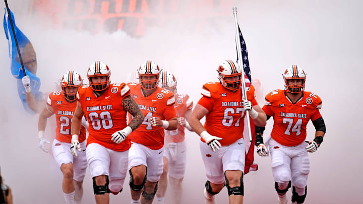 Oklahoma State runs on to the field before the college football game between the Oklahoma State Cowboys and South Dakota State Jackrabbits at Boone Pickens Stadium in Stillwater, Okla., Saturday, Aug., 31, 2024.