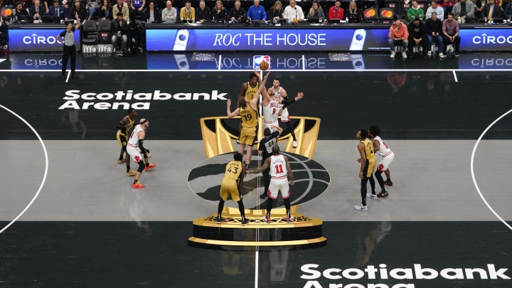 Nov 24, 2023; Toronto, Ontario, CAN; Toronto Raptors center Jakob Poeltl (19) and Chicago Bulls center Nikola Vucevic (9) on the tip-off during the first half on the In-Season Tournament floor at Scotiabank Arena. Mandatory Credit: John E. Sokolowski-USA TODAY Sports